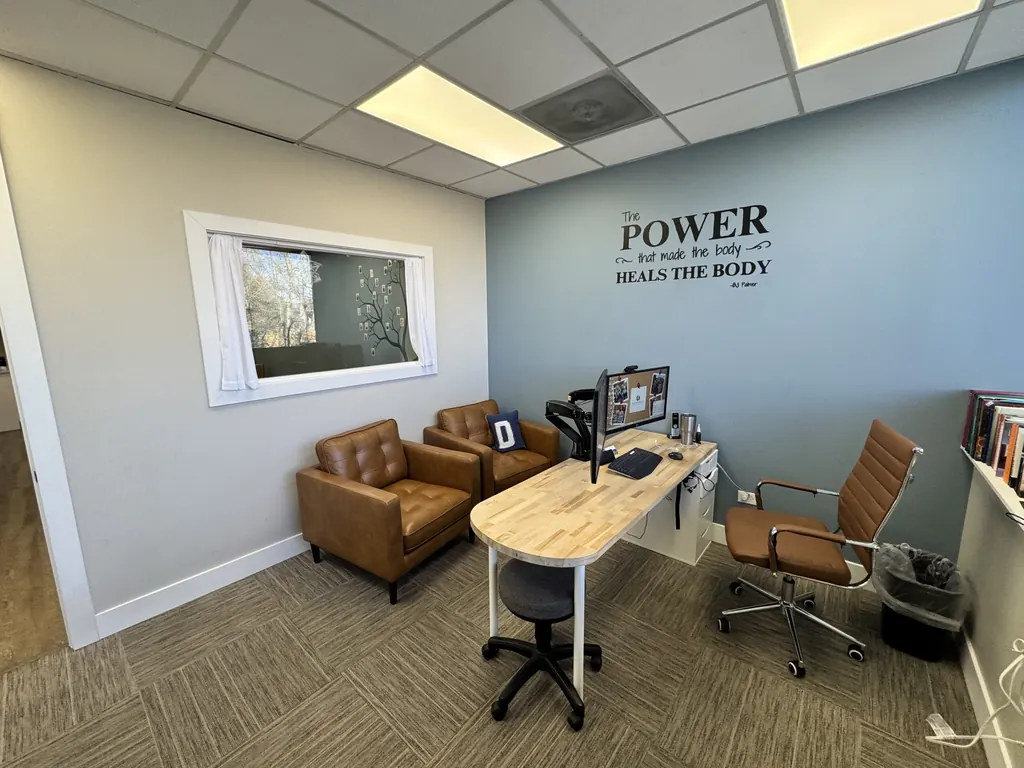 Consultation room at Dody Chiropractic with a desk and chairs where Dr. Dody reviews findings