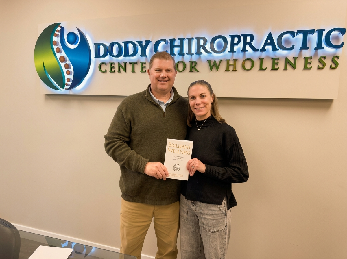 Dr. Michael Dody and Heather Dody holding Brilliant Wellness book